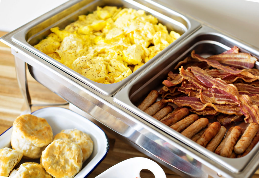 breakfast catering: eggs, sausage, bacon and biscuit